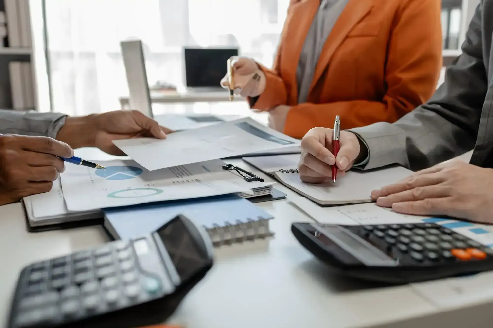 Tax professionals reviewing financial documents with calculators